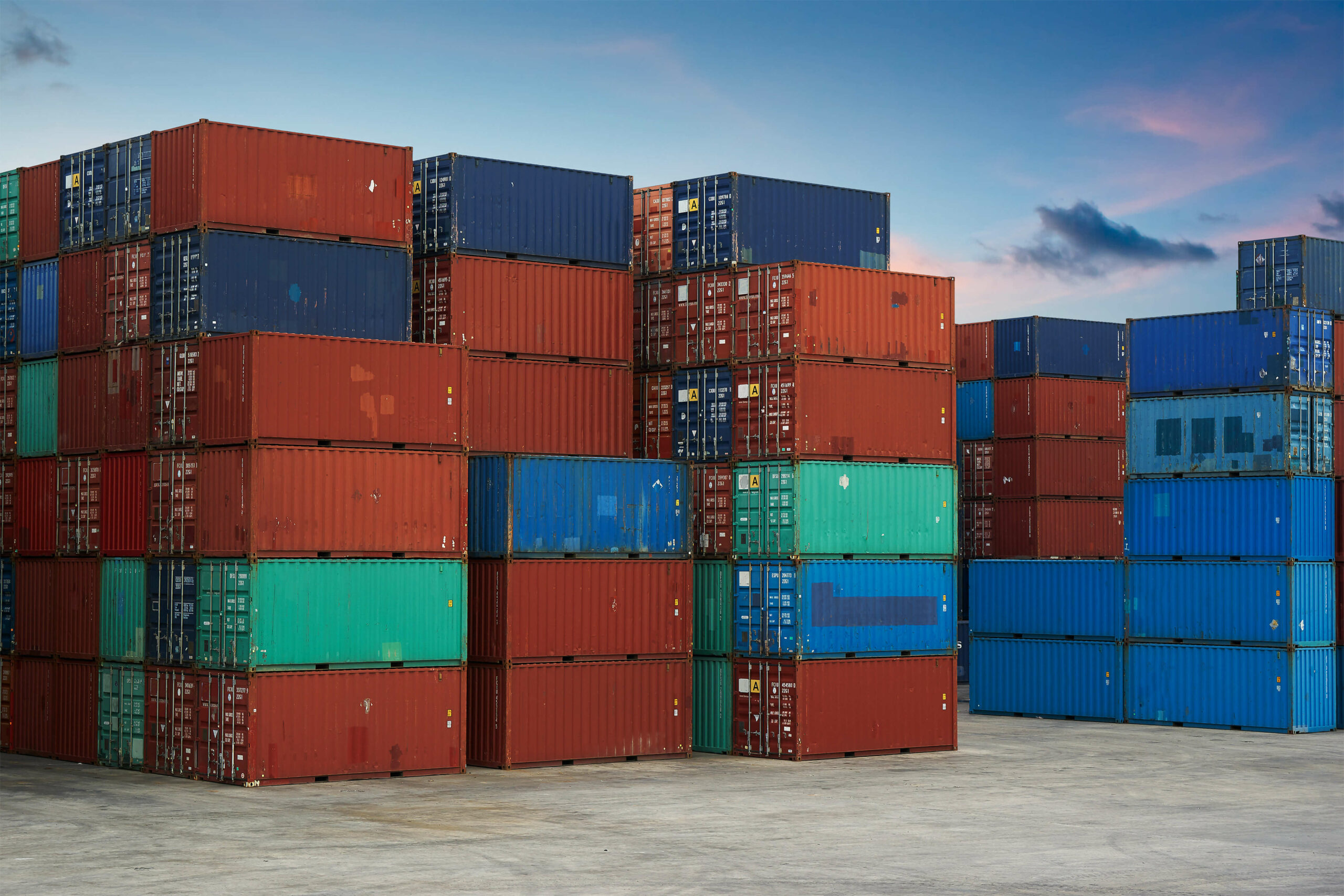stack-of-cargo-containers-at-the-docks-SBI-301985814